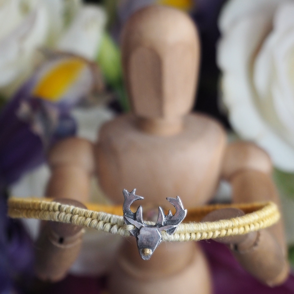 Fine silver stags head charm on a orange friendship bracelet