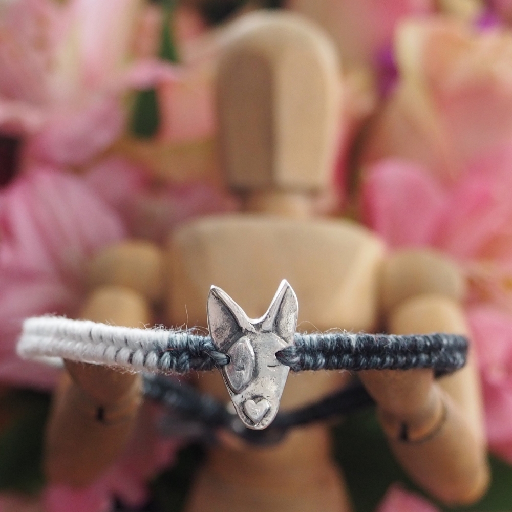 Fine silver bulldog charm on a grey friendship bracelet