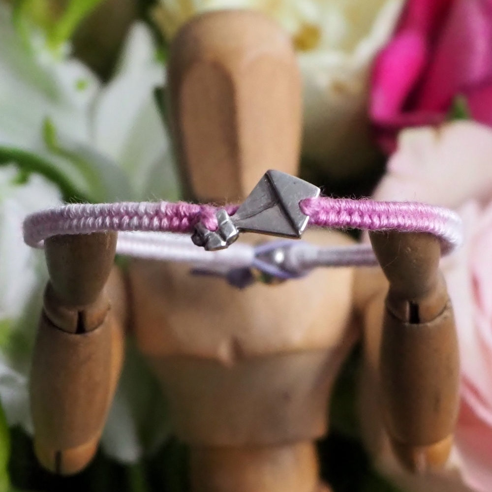 Fine silver kite charm on a purple friendship bracelet