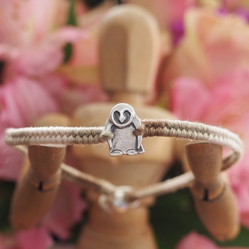 Fine silver owl charm on a brown friendship bracelet