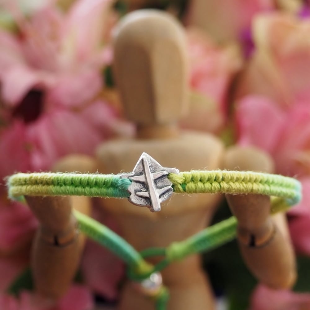 Fine silver ivy leaf charm on a green friendship bracelet