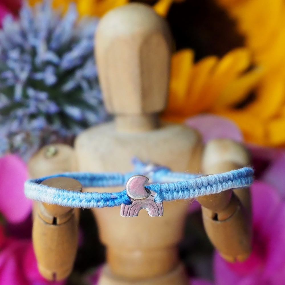 Fine silver moon charm on a blue friendship bracelet