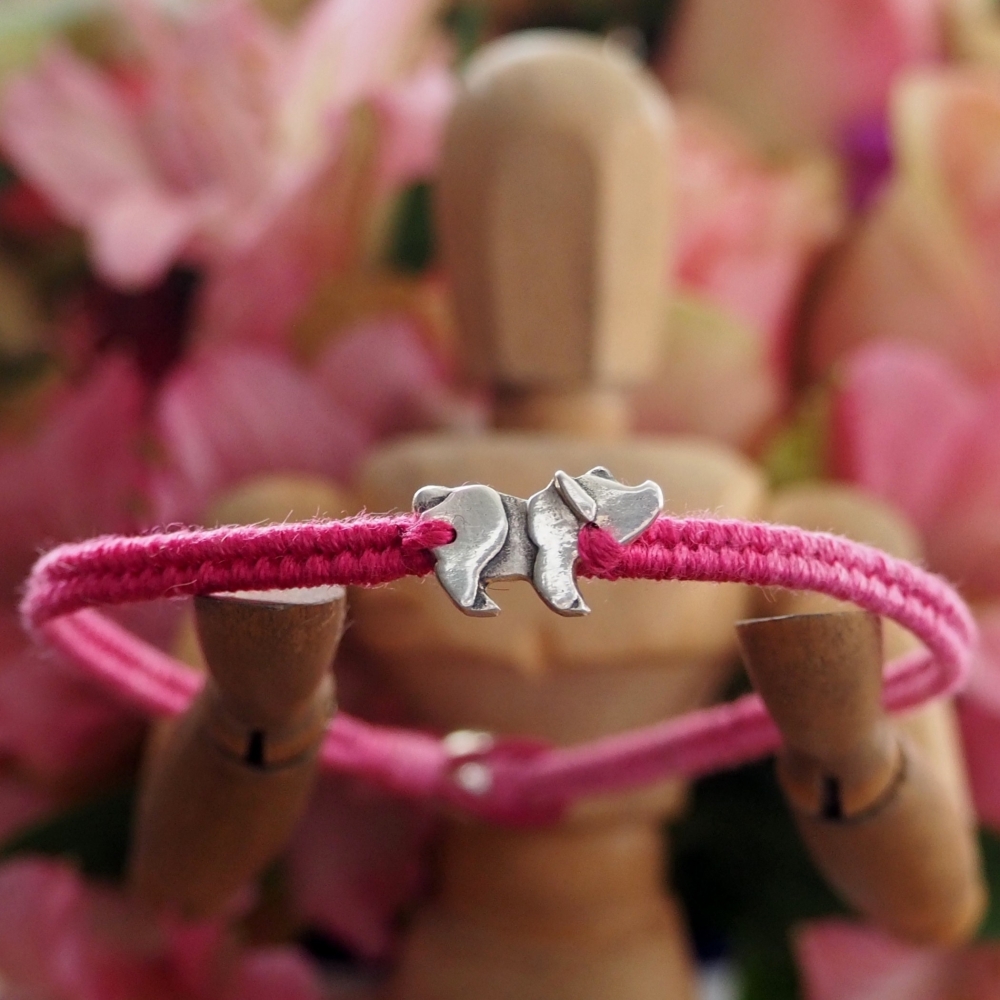 Fine silver pig charm on a pink friendship bracelet
