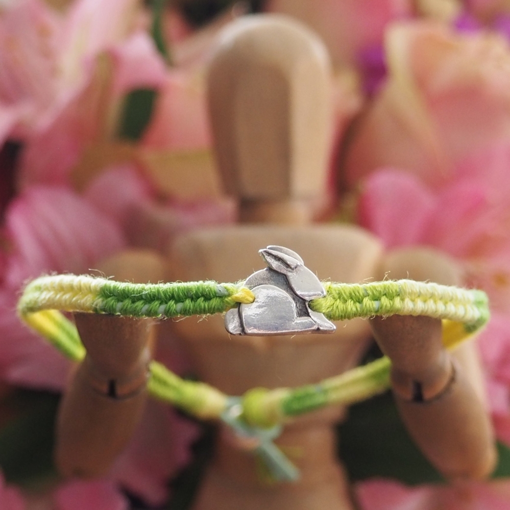Fine silver rabbit charm on a green friendship bracelet