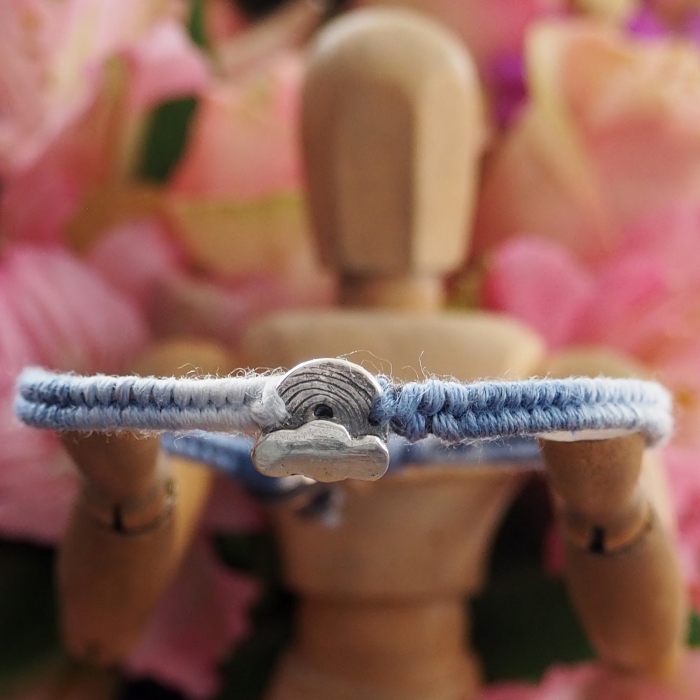 Fine silver cloud and rainbow charm on a blue friendship bracelet