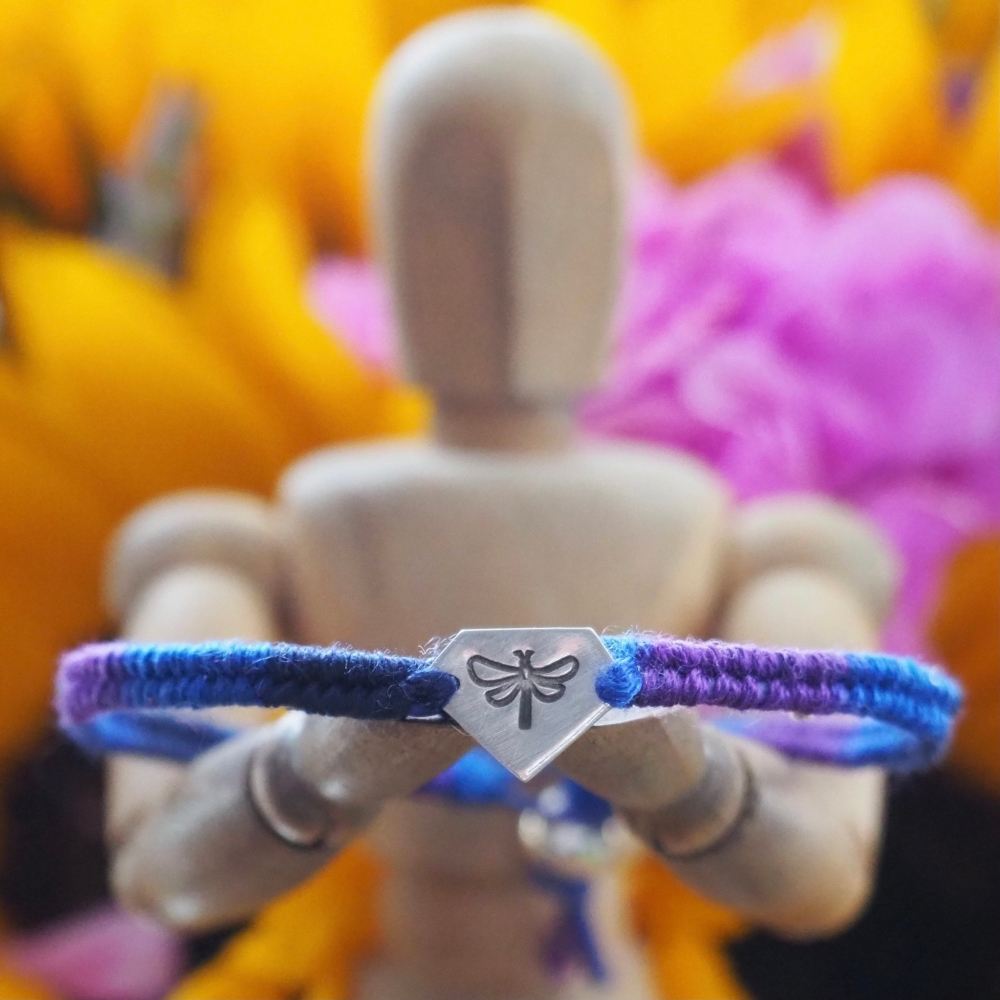 Fine silver charm with dragonfly stamp on a blue friendship bracelet