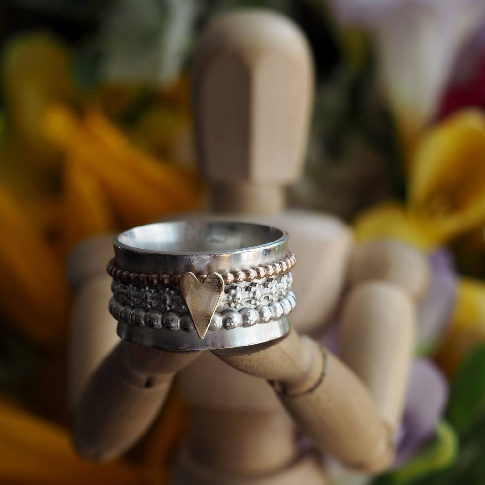 Sterling silver spinner ring with gold heart