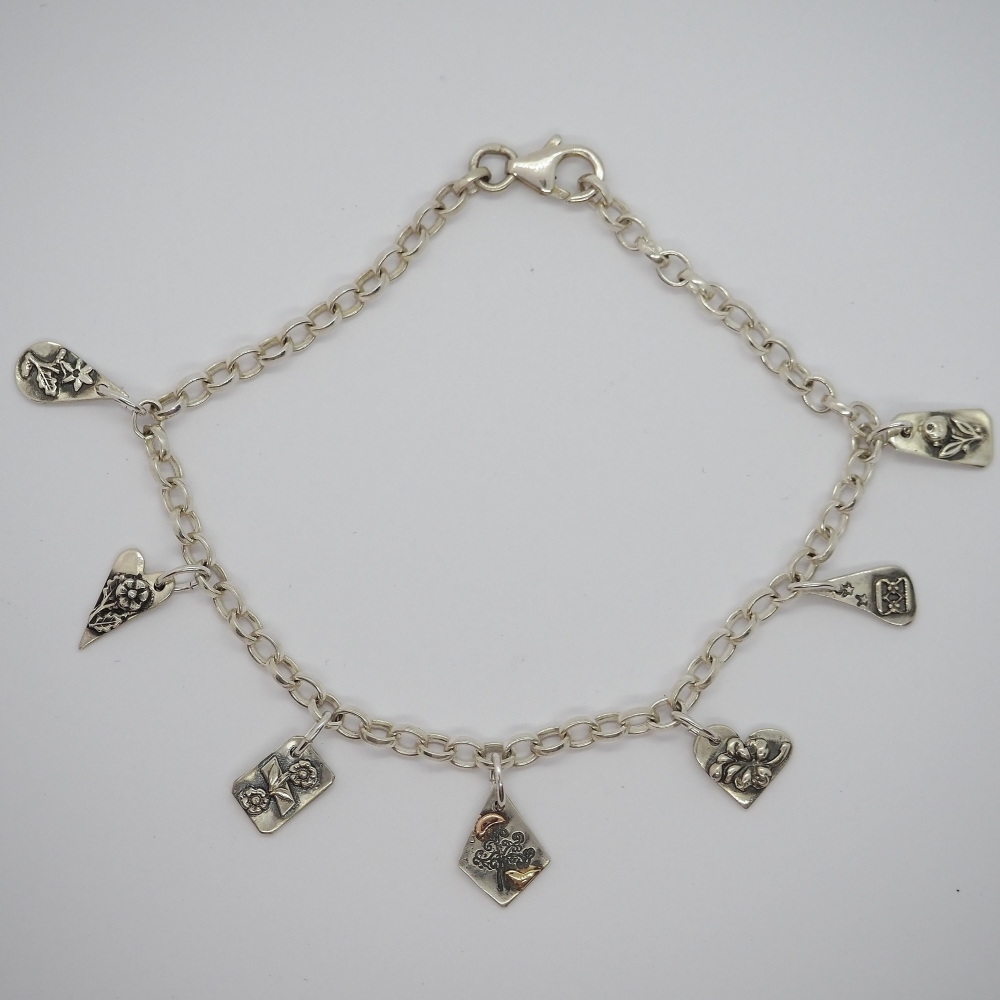 Charm bracelet with recycled silver and gold charms