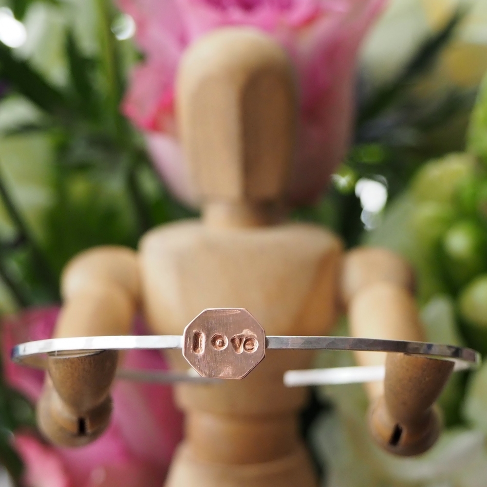 Sterling silver bangle with copper stamped with 'love'