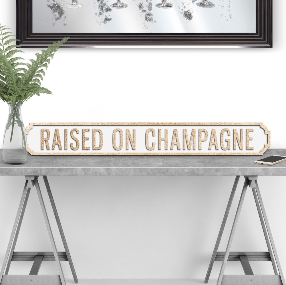 Raised on Champagne Street sign in Gold