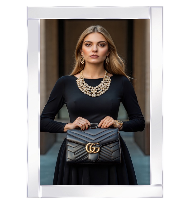 Mirror framed stylish lady in a sleek black dress, clutching a designer bag