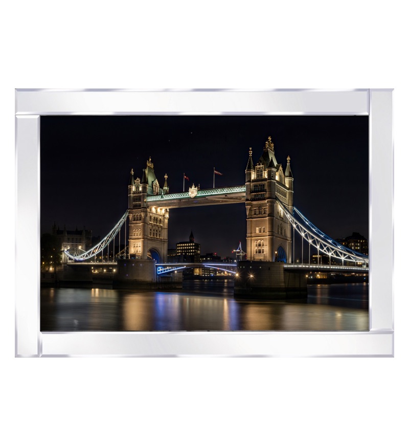 Mirror framed art print  Tower Bridge glows at night, its reflection shimmering in the water