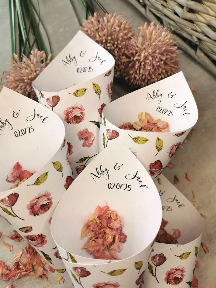 Personalised pink flower wedding confetti cones.