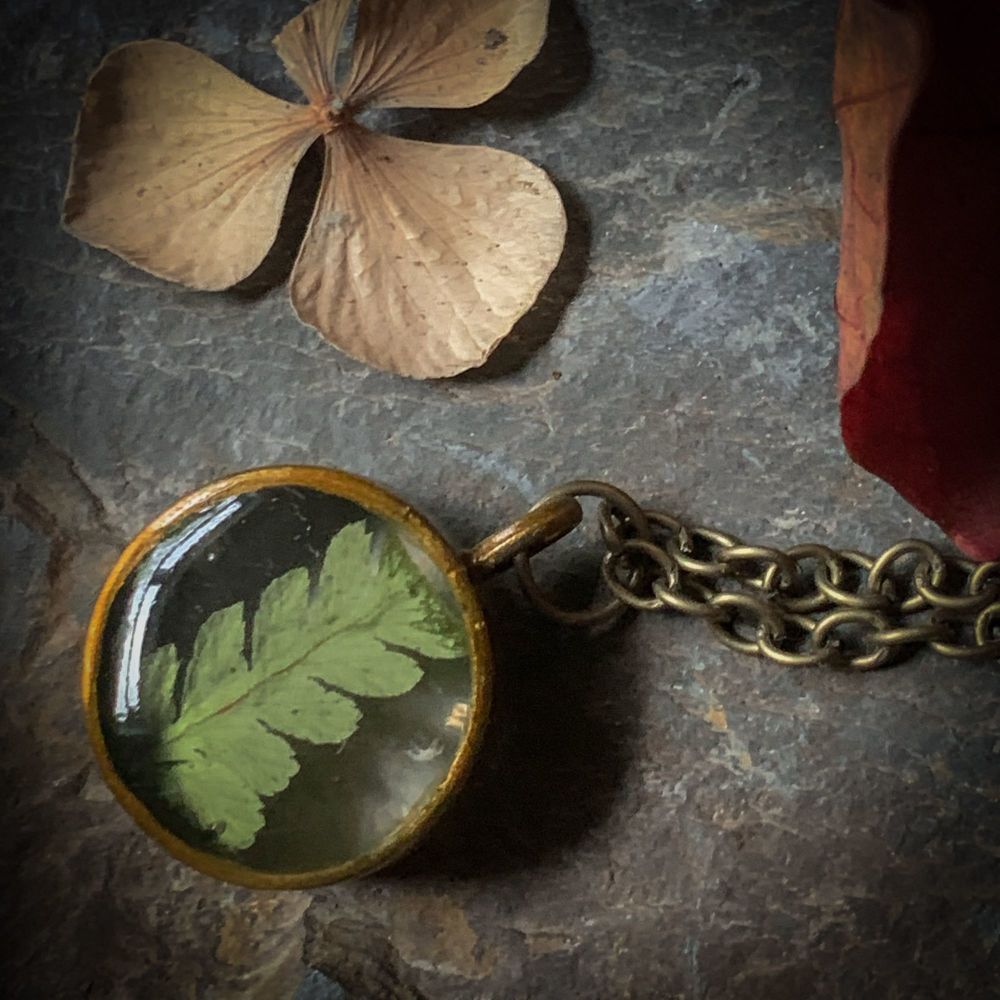 Small Fern Frond bezel pendant on an 18 inch antique brass chain -  slight 