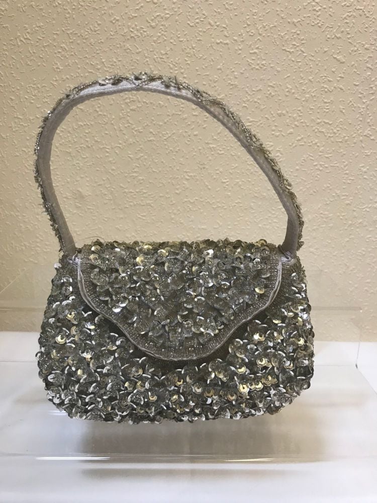 Silver sequin with handle and popper flap fastening