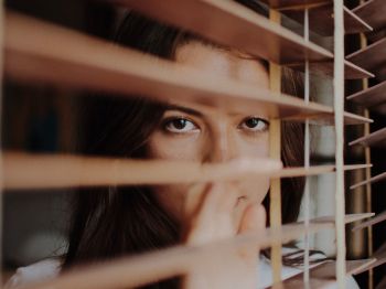 woman staring out of window