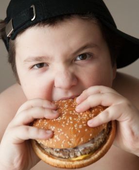 boy eating burger cropped