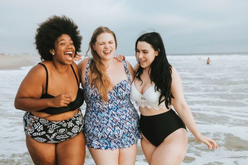 Cheerful-plus-size-women-enjoying-the-beach-1076523906_3869x2579