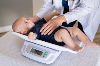 Doctor-weighing-baby-1219122075_2125x1416