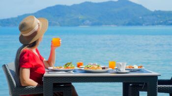 Woman-enjoy-beautiful-and-healthy-breakfast-at-luxury-hotel-by-the-sea-in-t