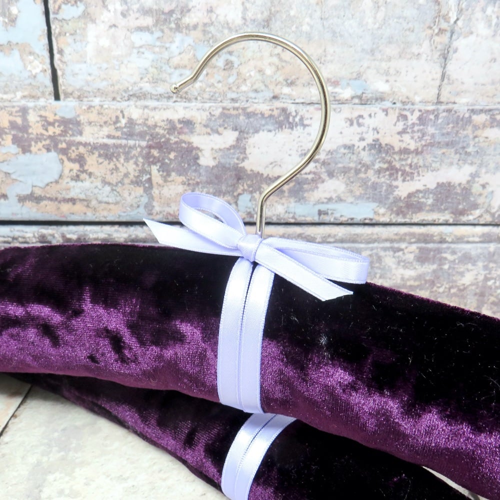 Pair of purple padded coat hangers