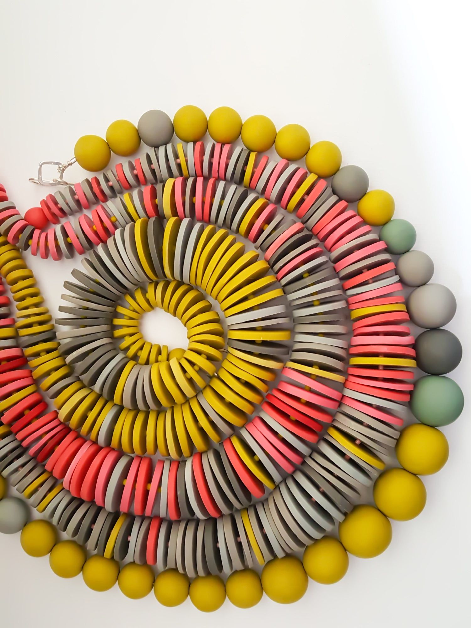 Handmade polymer clay disc and round beads in mustard coral and grey handmade by Clare Lloyd Jewellery