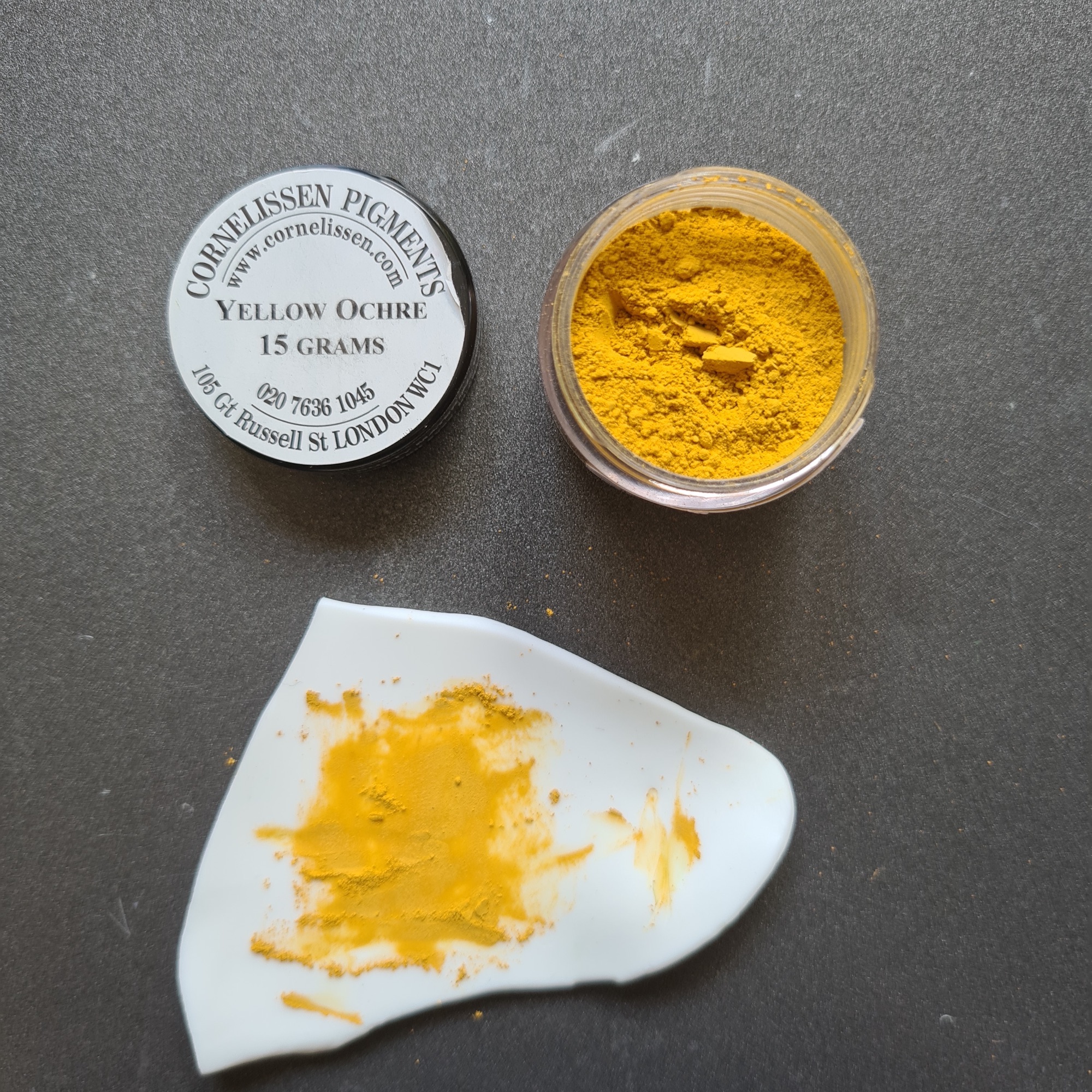 yellow ochre powdered artists pigment mixed into porcelain white polymer clay