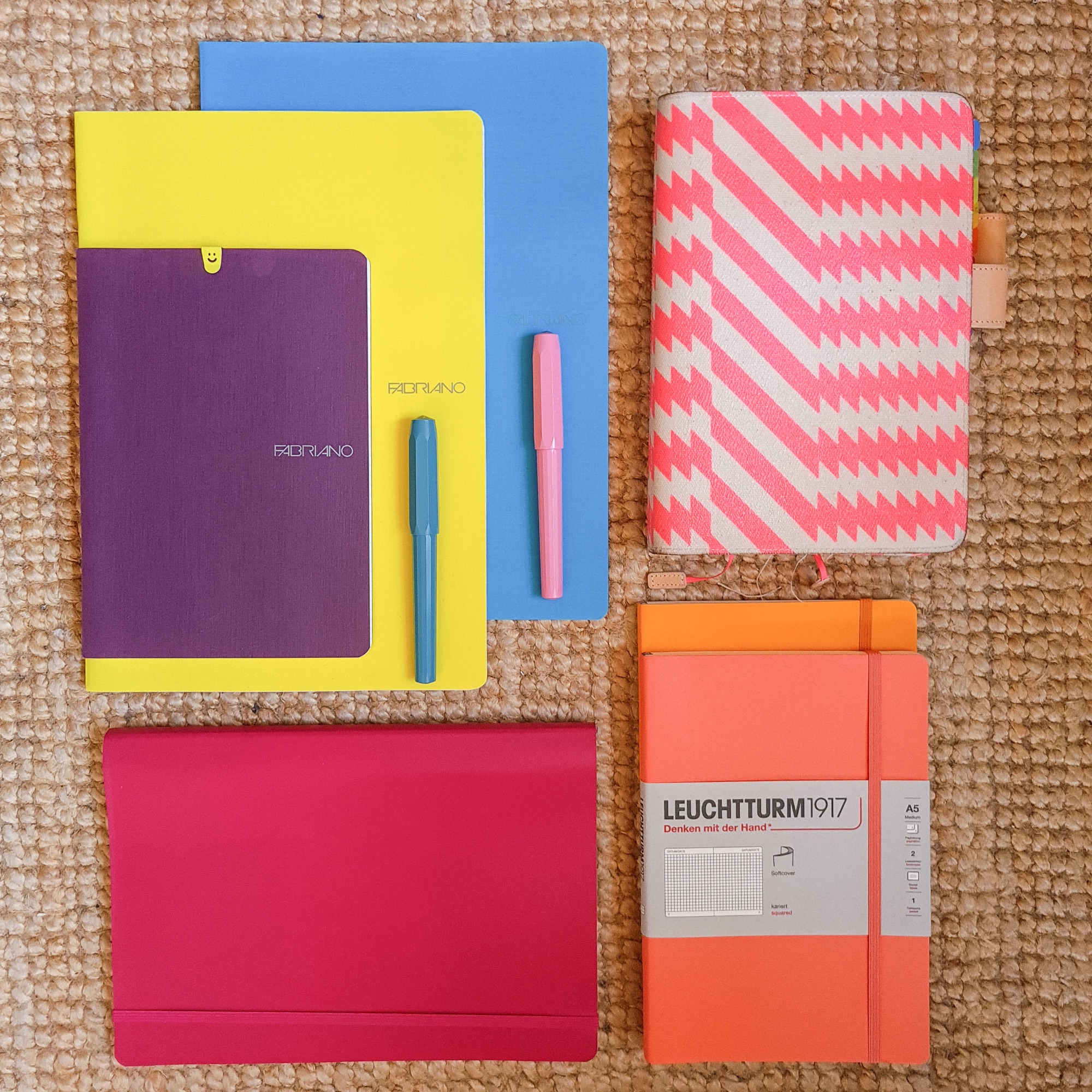 Flaylay of colourful notebooks and pens