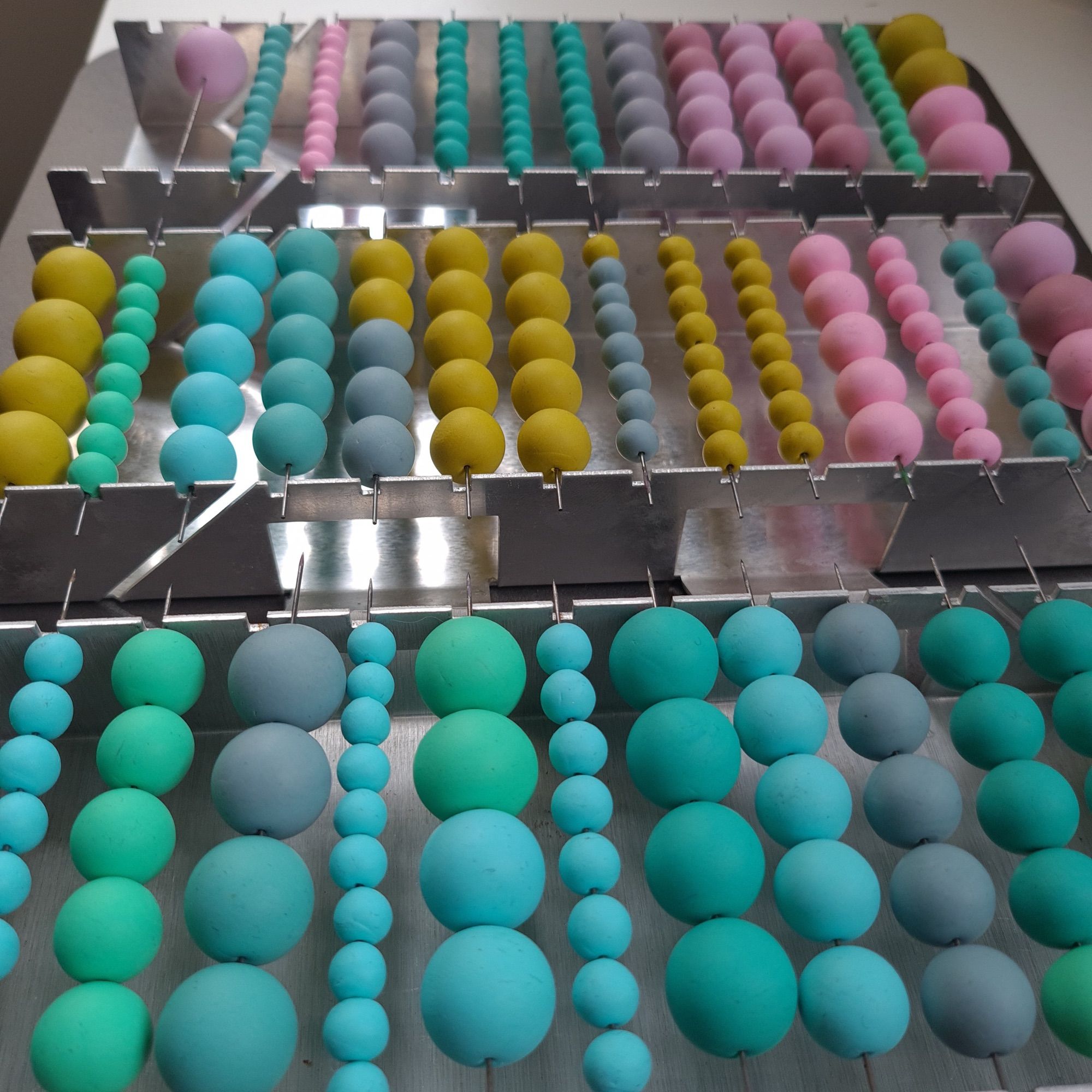 Handmade polymer clay beads on a bead rack 