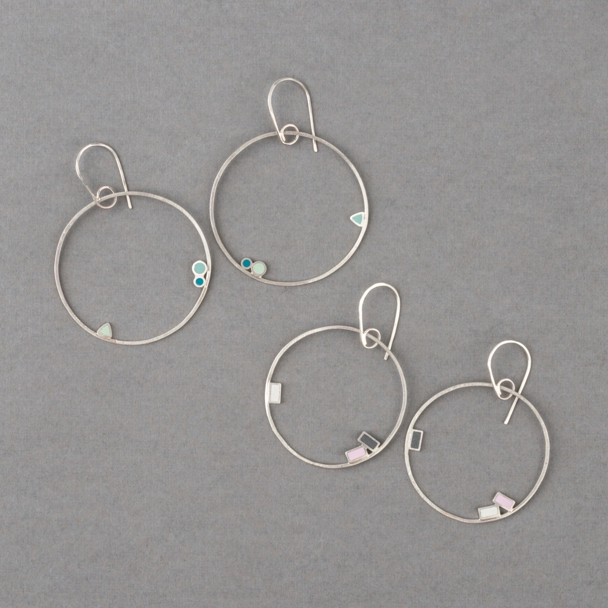 Recycled sterling silver hoop earrings with little dots of colourful resin handmade by Clare Lloyd Jewellery
