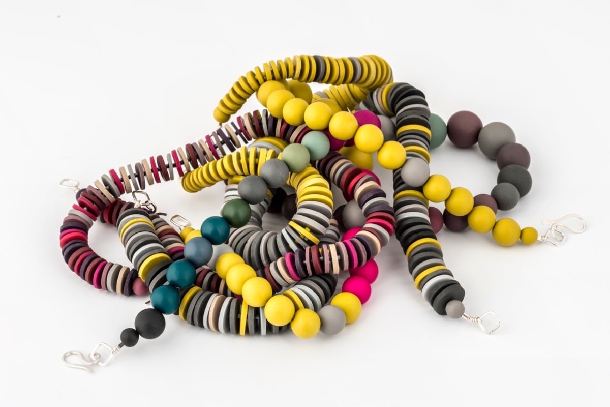 a jumbled up pile of handmade polymer clay beaded necklaces by Colour Designs Jewellery