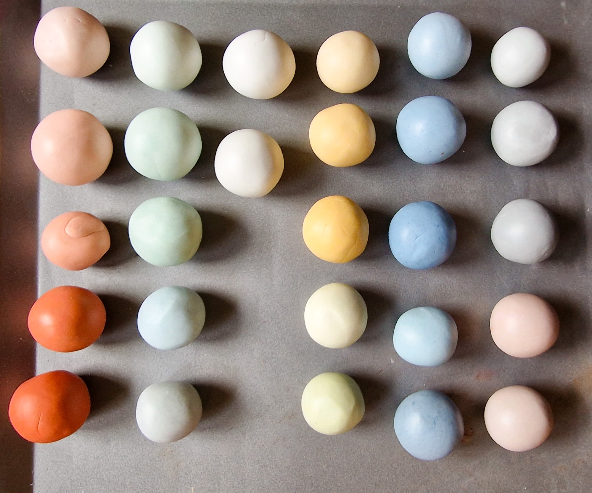 Balls of polymer clay mixed with pigments ready to make into beads