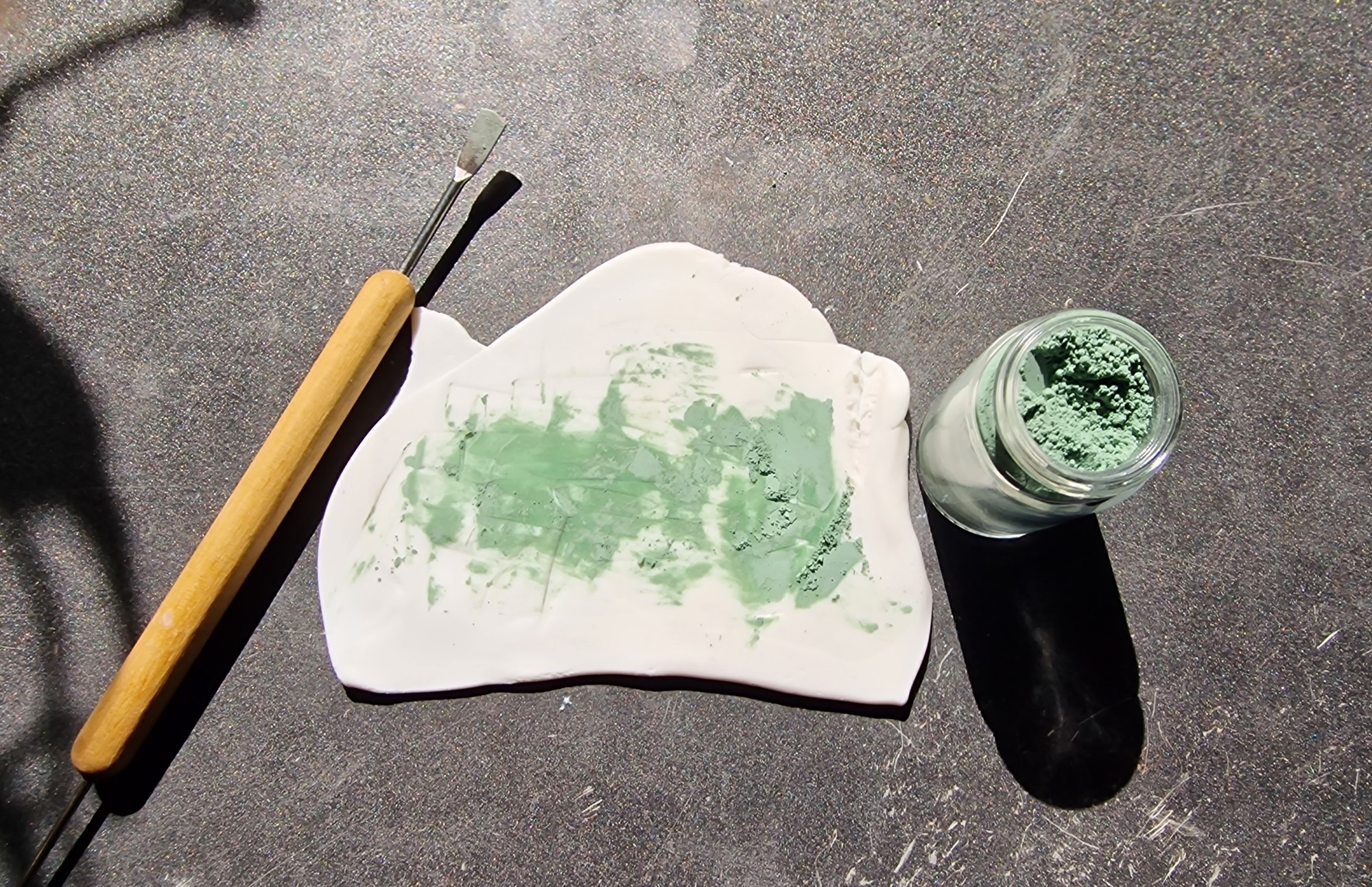 Mixing green earth pigment into polymer clay