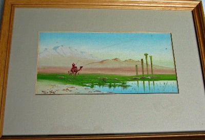 Man on camel in Egyptian desert near ruins, gouache on paper, signed Felix