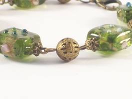 close up of green lampwork bracelet