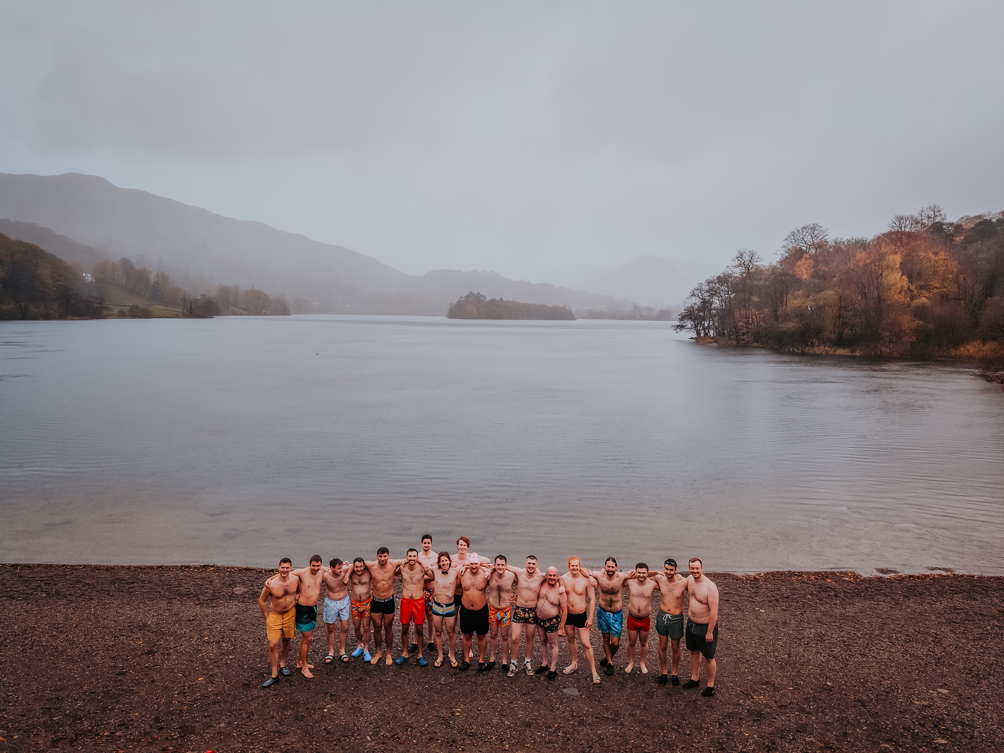 Bride and friends taking an early morning wild swim in the Lake District before the wedding ceremony.