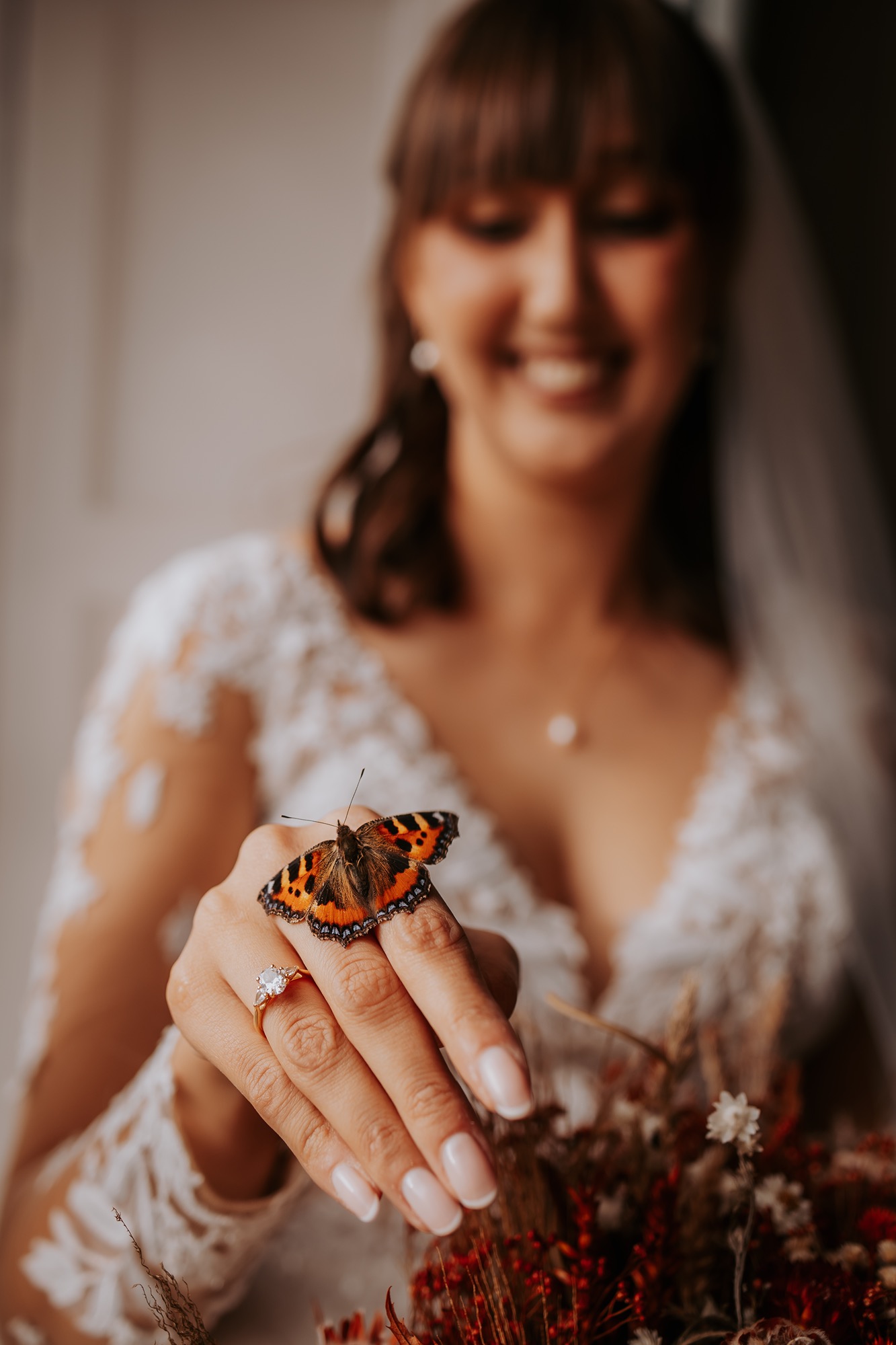Butterfly wedding visitor, matching rust-coloured foliage.