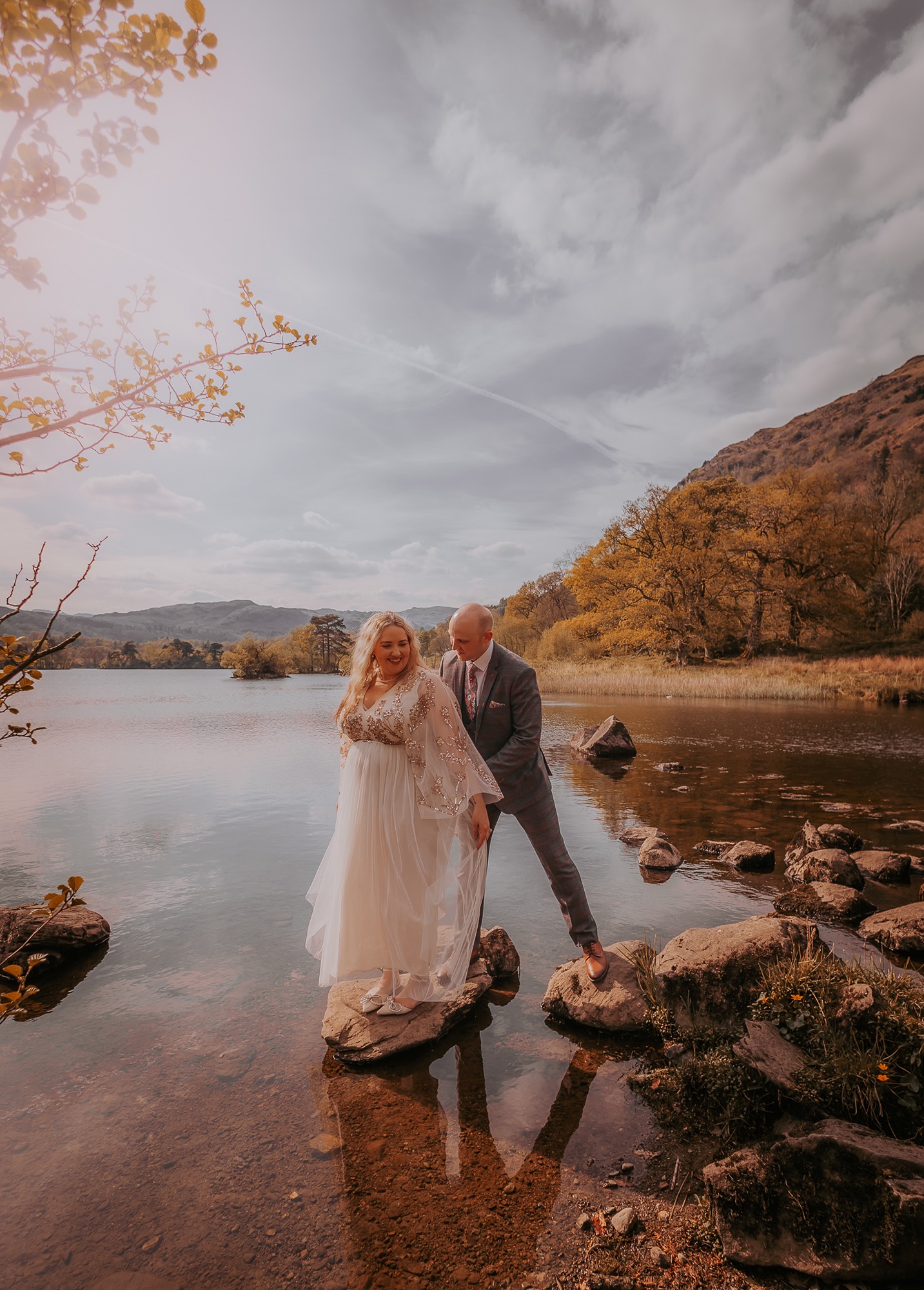 Bride and Groom on stepping stones at Rydal Water, Ambleside
