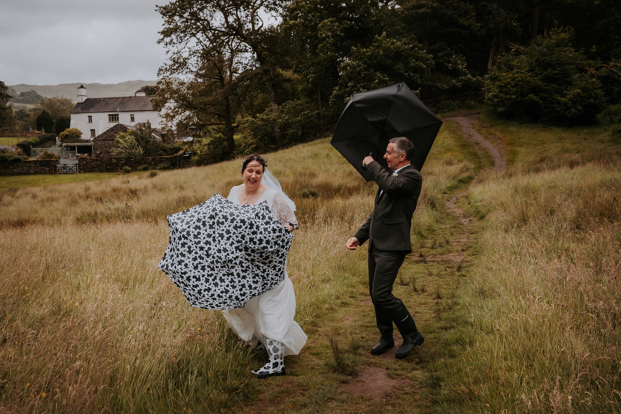 Windy weather at Rydal water as bride and groom brave the storm