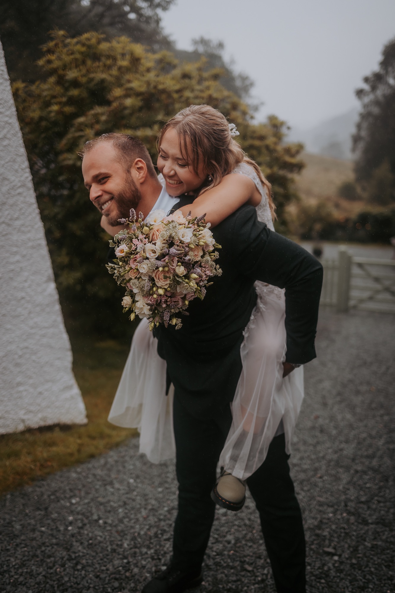 Groom carried bride in a piggyback as they return to Cote How after a visit to Rydal caves