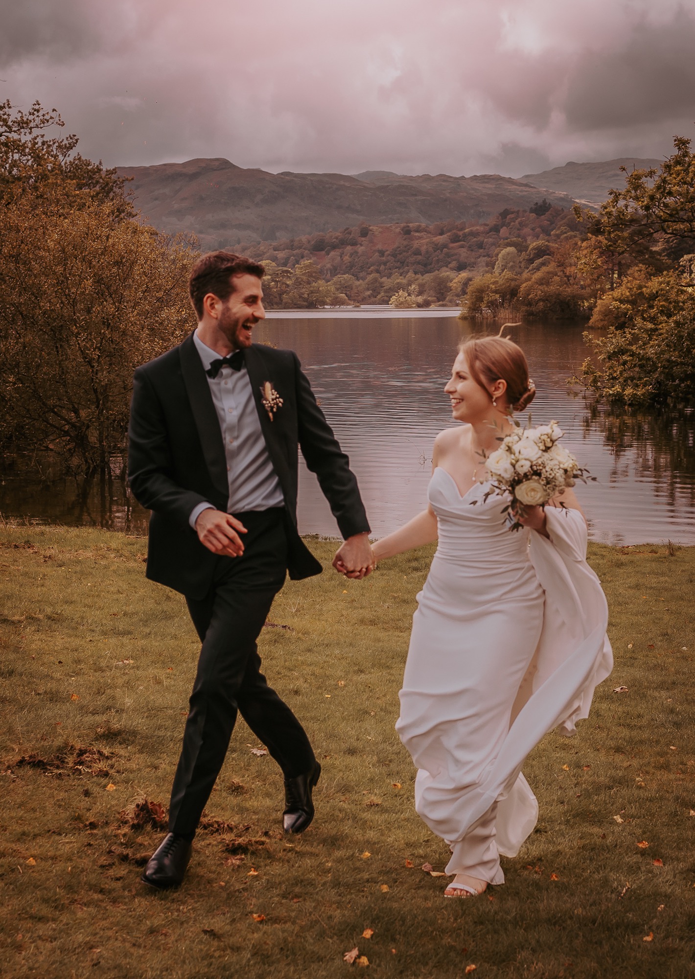 Bride and Groom holding hands on shores of Rydal water, Ambleside