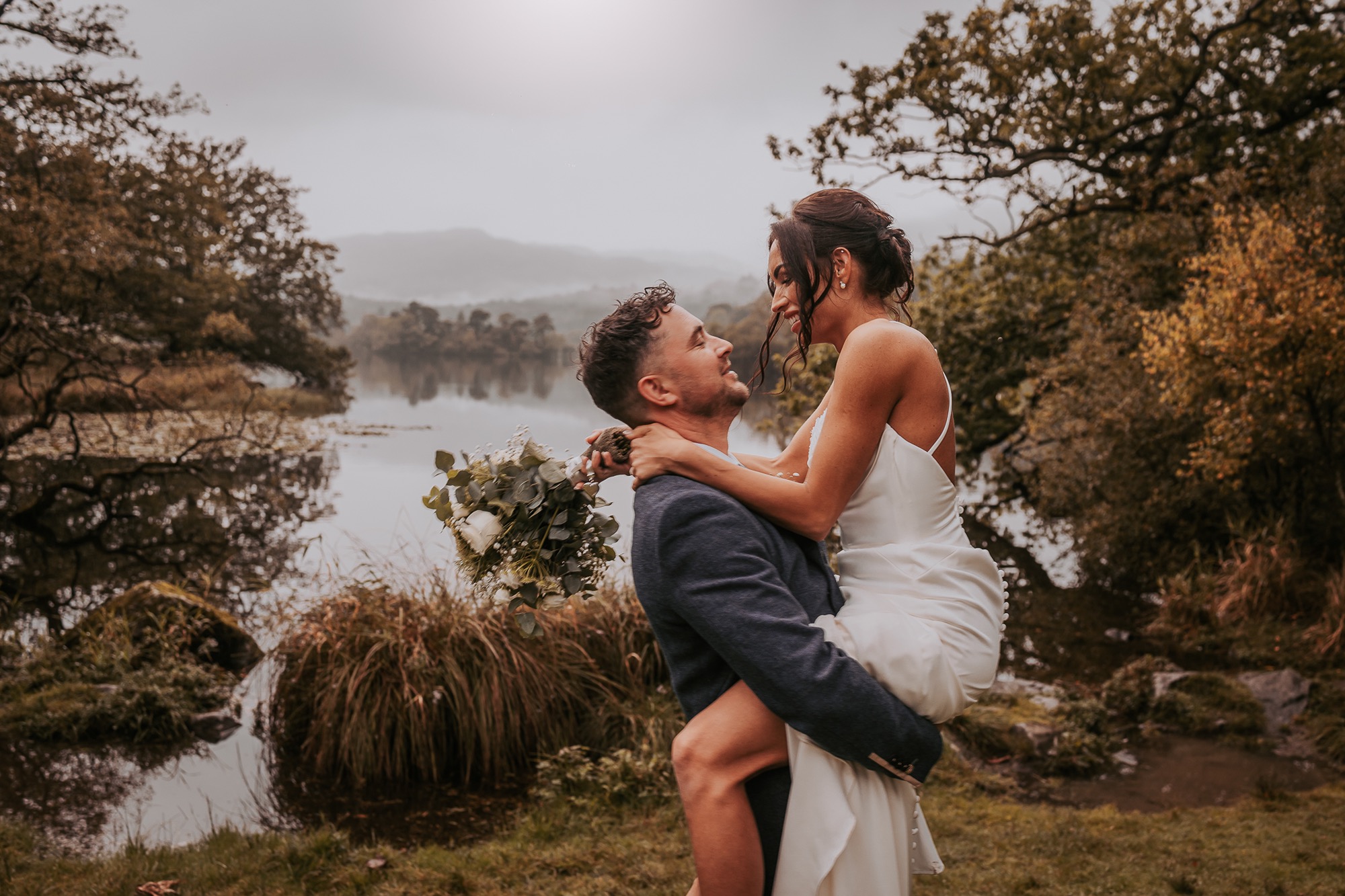 Groom lifting bride by the side of Rydal water, Ambleside