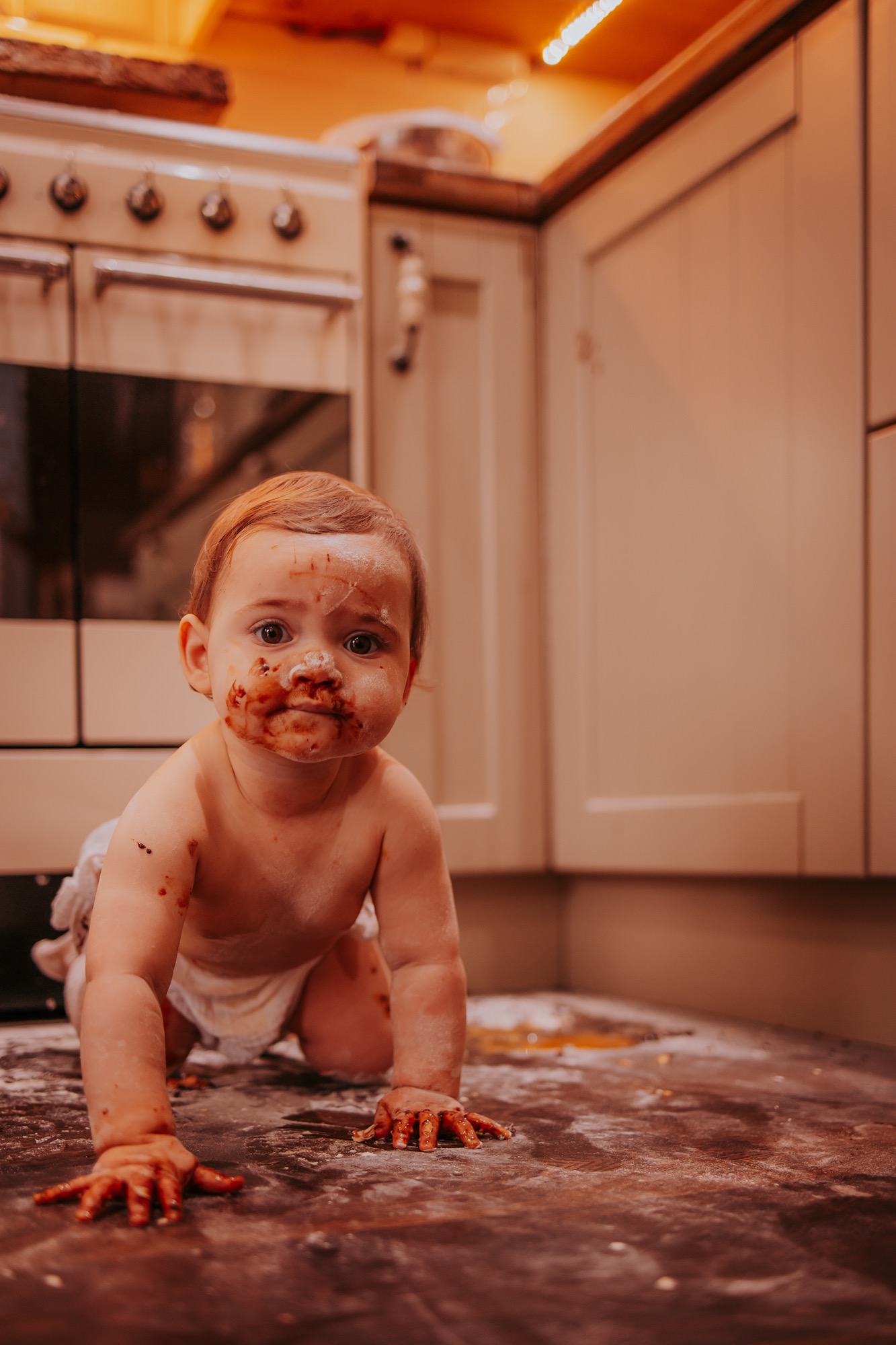 1 year old portrait in the kitchen after a cake bake