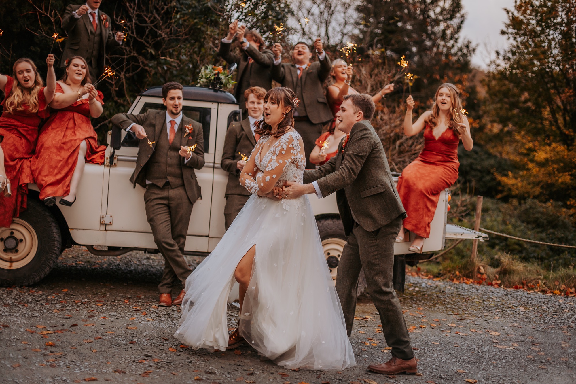 Couple dancing as the sunsets, whilst gusts enjoy sparklers on the vintage landcover at Lancrigg, Grasmere