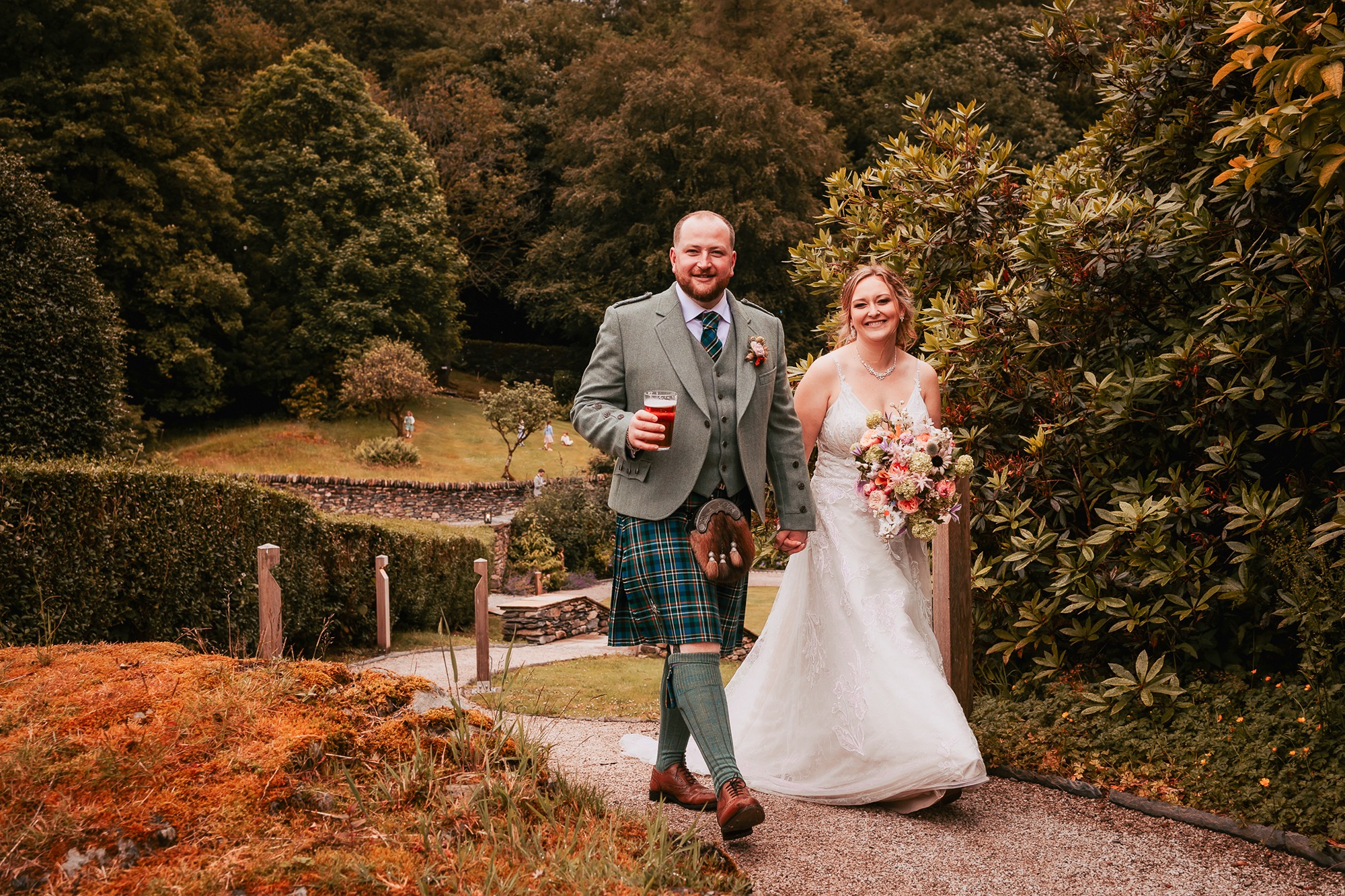 Wedding couple enjoying a walk about Town Head Estate gardens in the afternoon of their wedding