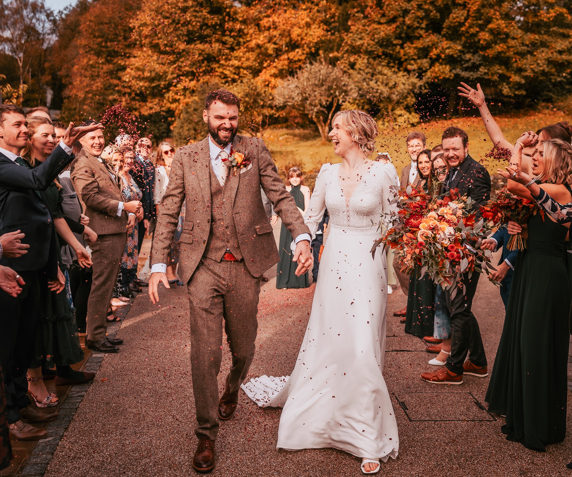 Newly weds walking down confetti aisle in Town Head Estate grounds
