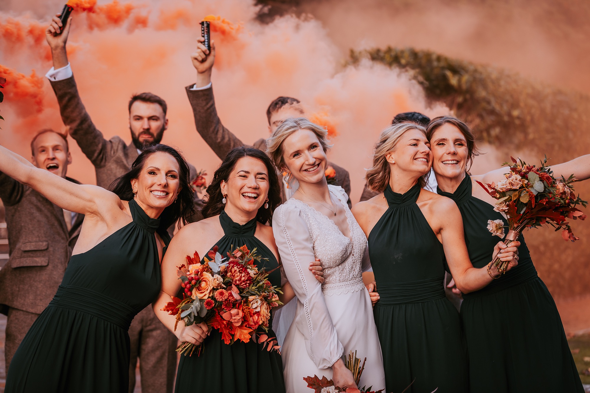 Bridal party using orange smoke grenade at Autumnal styled wedding at Town Head Estate