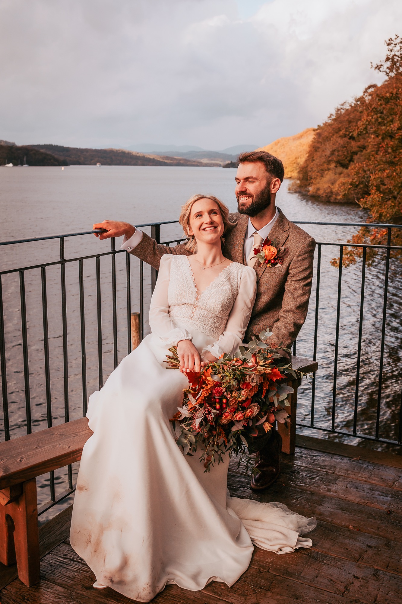 Bride and groom on the boat house balcony overlooking Windermere at Town Head Estate
