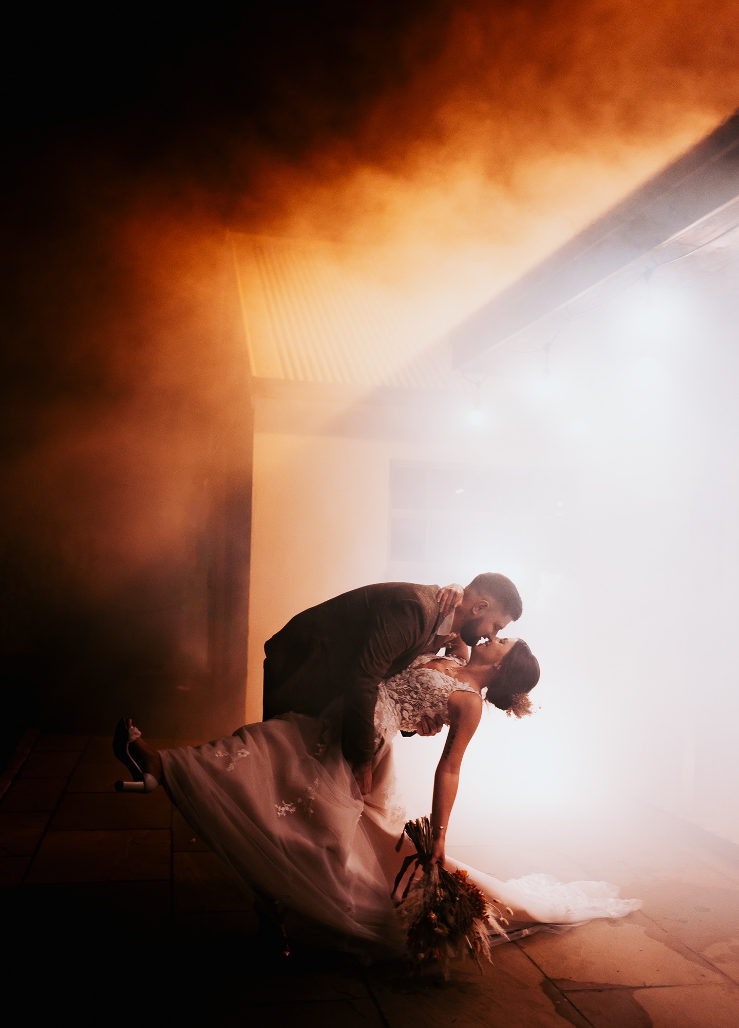 newly married couple doing sexy wedding dip with atmospheric background at Eden Wedding Barn, Cumbria