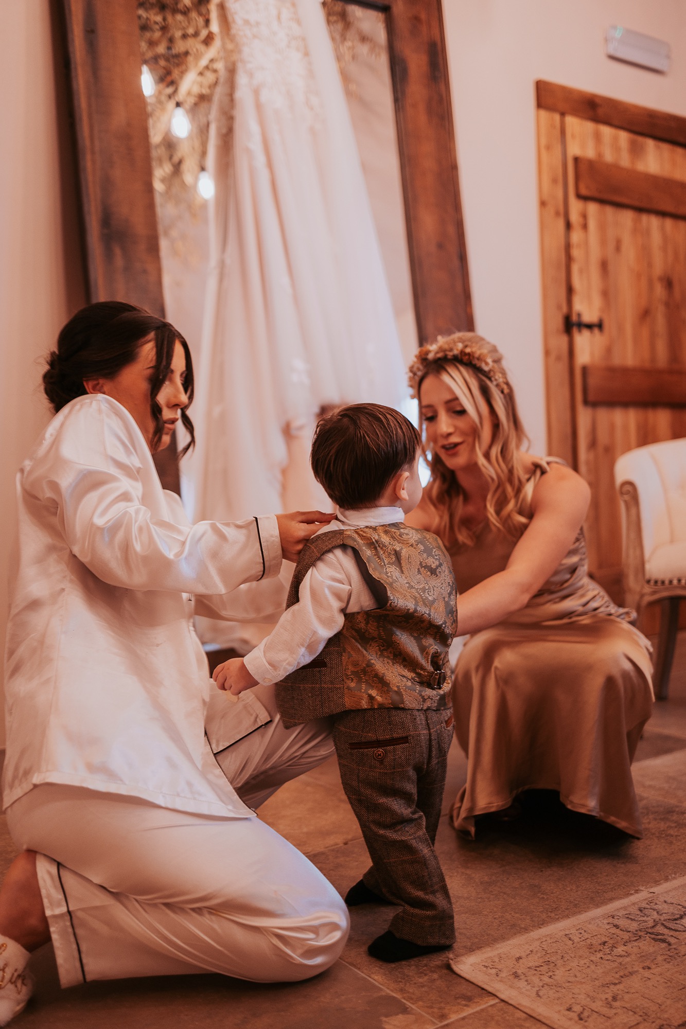 Bride dresses page boy in bridal suite at Eden Wedding Barn